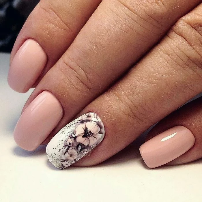 nude base on medium length squoval nails spring nail designs white base with watercolor flowers decorations on ring finger