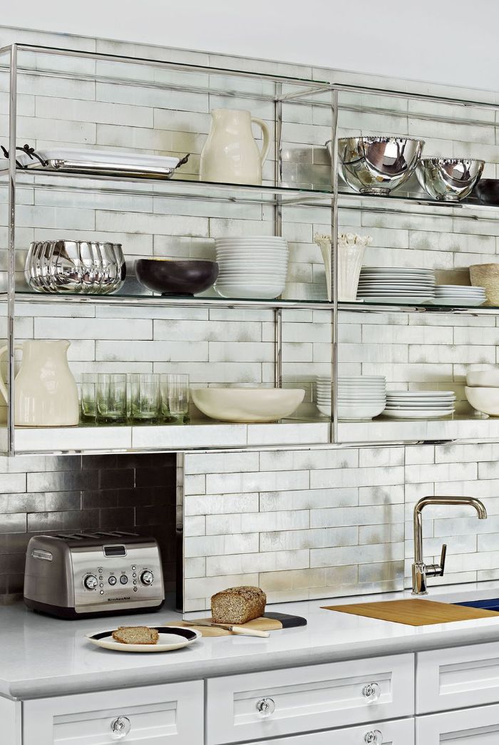 open kitchen cabinets metallic glass shelves white subway tiles backdrop above white cabinets