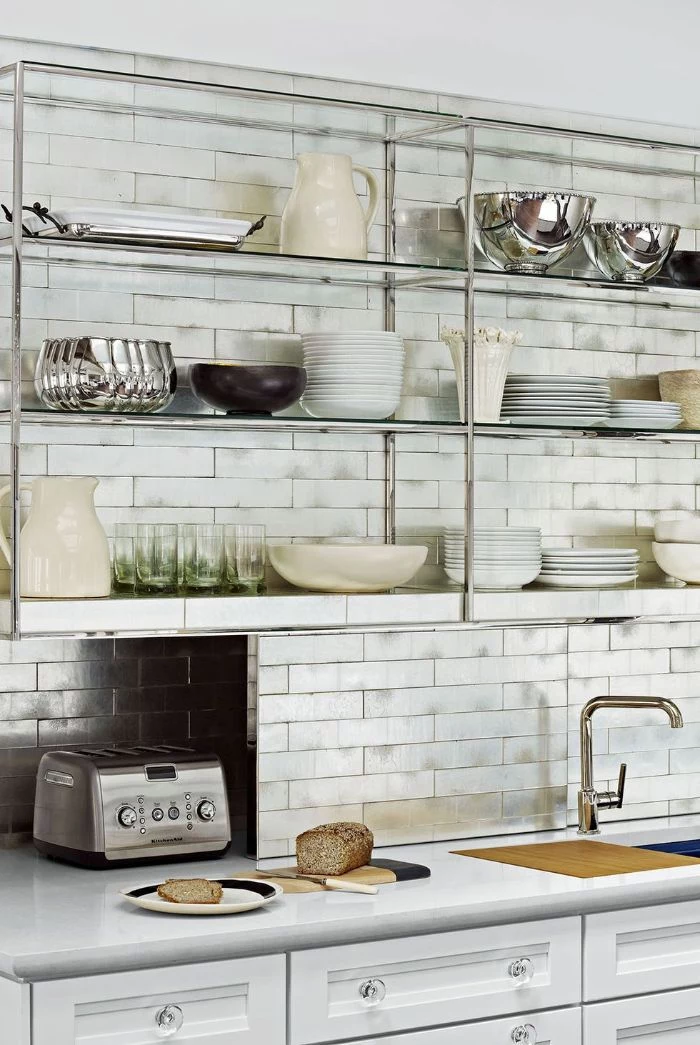 open kitchen cabinets metallic glass shelves white subway tiles backdrop above white cabinets