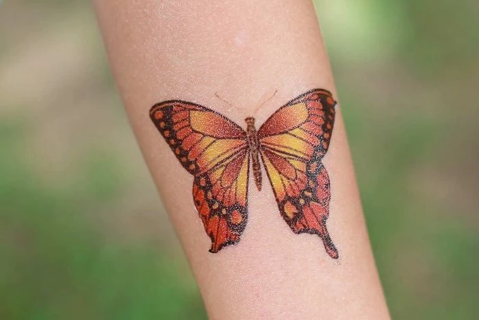 orange yellow and black butterfly traditional butterfly tattoo forearm tattoo