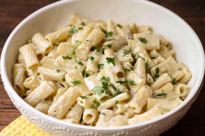 pasta cooked with creamy garlic sauce homemade noodle recipe placed in white bowl