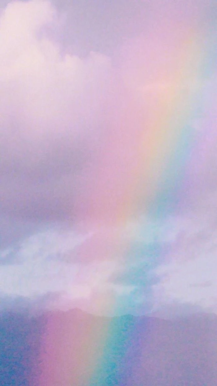 photo of the sky filled with clouds cute colorful wallpaper rainbow going through the photo
