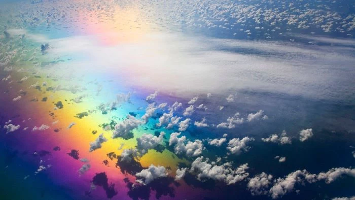 photo taken from above the clouds over ocean boho rainbow wallpaper rainbow under the clouds