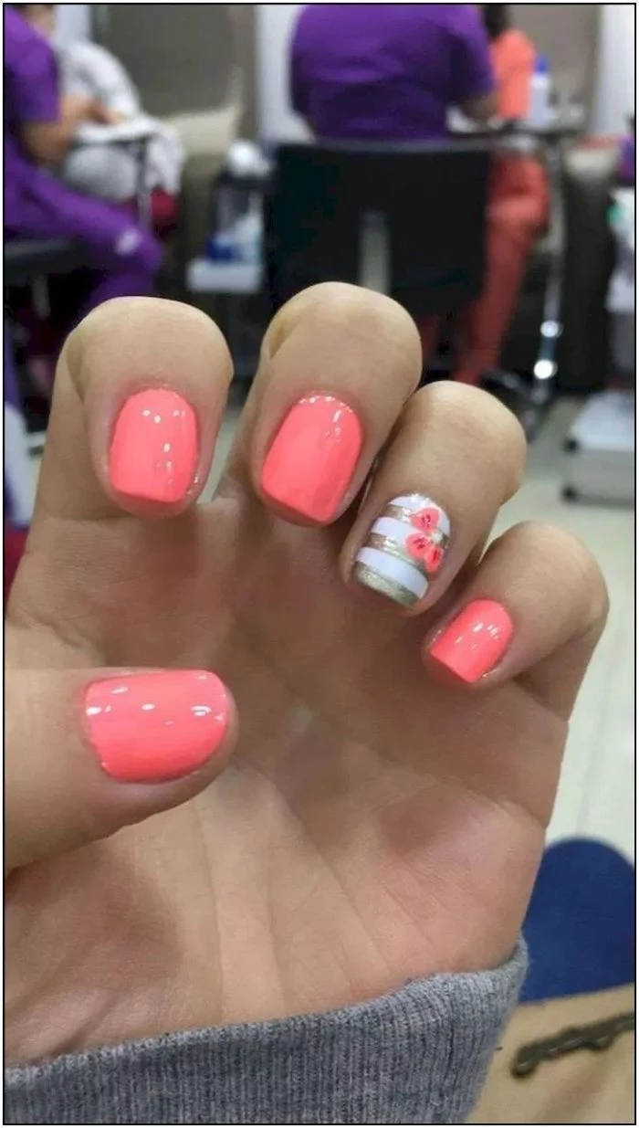 pink nail polish on short squoval nails 2021 nail trends white and gold stripes with flower decoration on ring finger