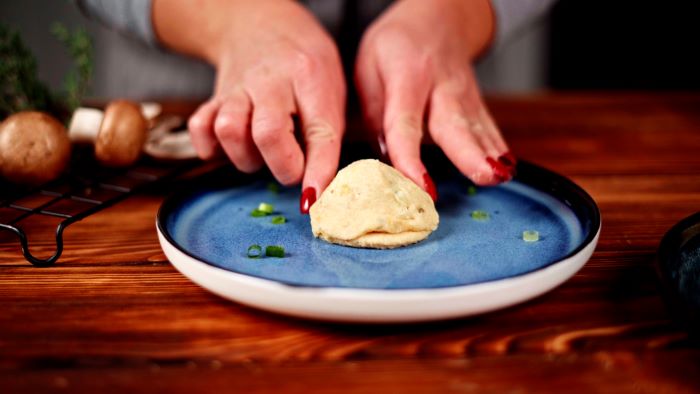 potato dough covering another one stuffed with mozzarella mushrooms easy party appetizers wild onion on the side