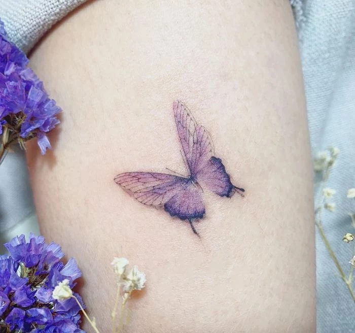 purple butterfly watercolor tattoo butterfly hand tattoo thigh tattoo two purple flowers on the side