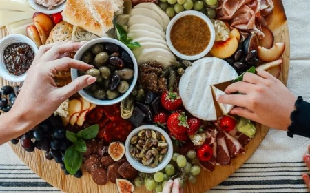 round wooden board charcuterie board ideas different types of cheese meat fruit veggies condiments