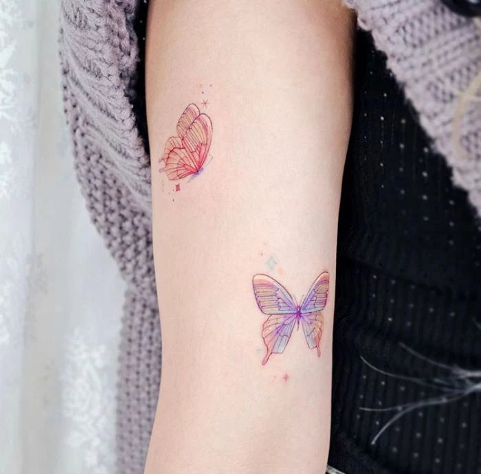 simple butterfly tattoo two butterflies in purple and orange forearm tattoo
