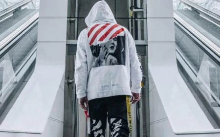 streetwear fashion man wearing all off white outfit white hoodie black pants black sneakers