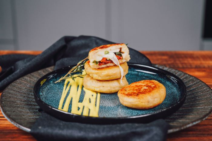 stuffed potato bites placed on blue ceramic plate appetizer recipes with sun dried tomatoes mozzarella