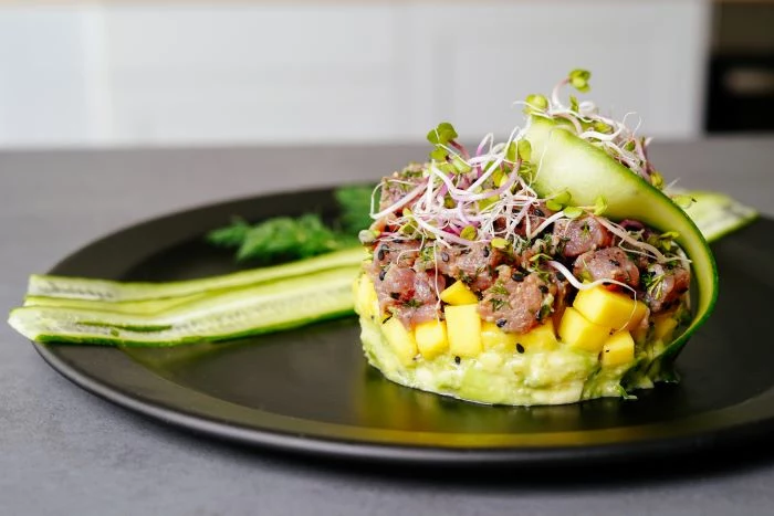 tuna tartare recipe with mango sprouts avocado cucumber appetizers for a crowd on black plate