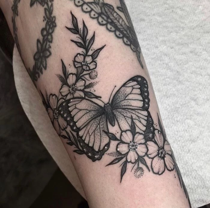 white background simple butterfly tattoo black and white butterfly with flowers around it