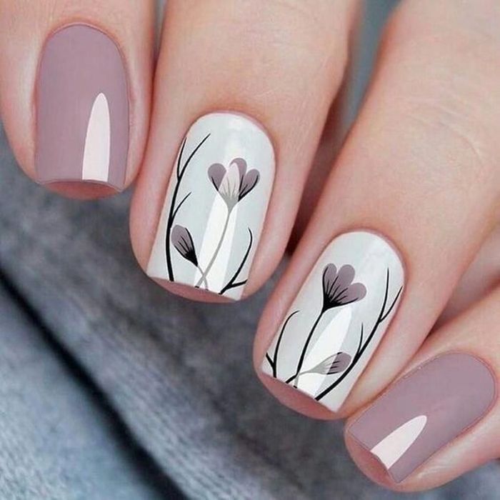 white base on ring and middle finger with flowers decorations spring nail designs light gray base on other fingers
