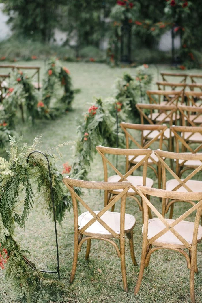 arrangements of garden flowers along the pathway backyard wedding chairs on both sides
