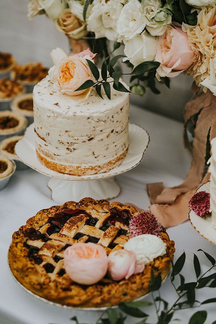 backyard wedding ideas dessert table with cake covered with white frosting and apple pie