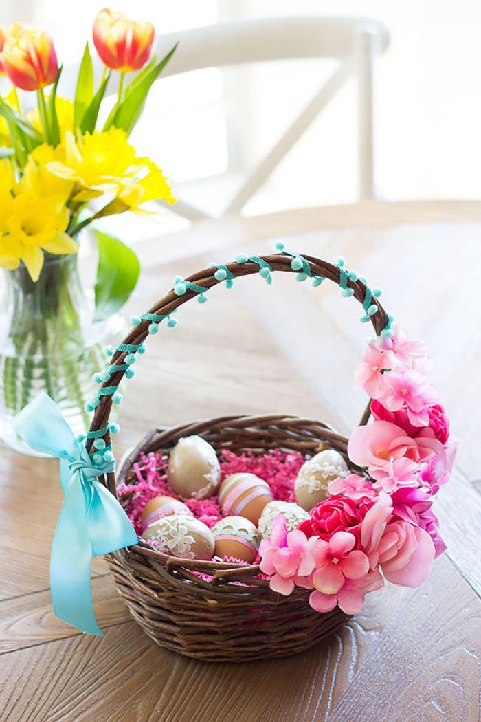 basket decorated with faux flowers and bow diy easter basket filled with dyed eggs