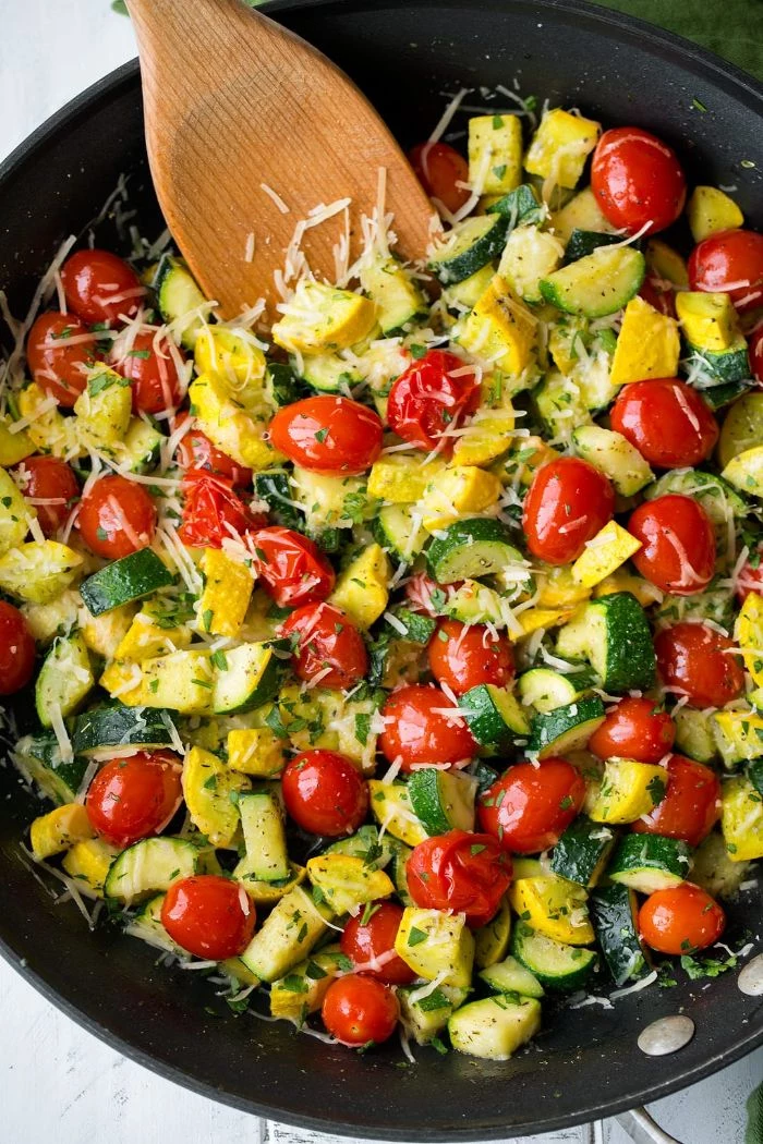 black skillet squash recipes zucchini squash and cherry tomatoes cooking with grated parmesan cheese