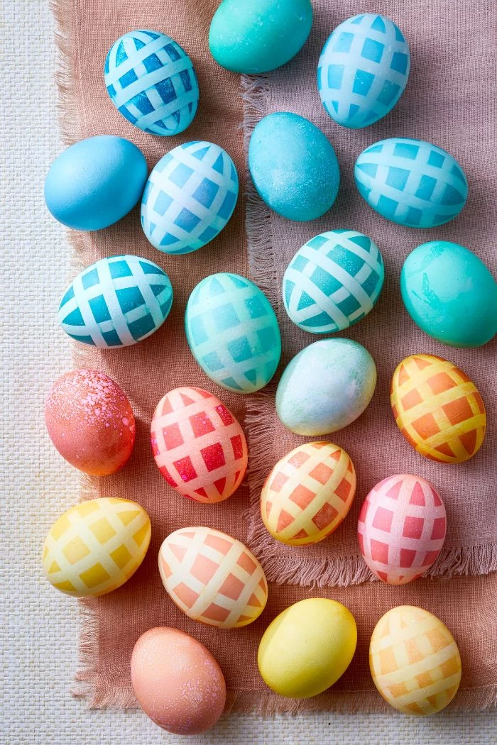 blue orange yellow pink eggs with fun pattern how to dye easter eggs placed on pink table cloth