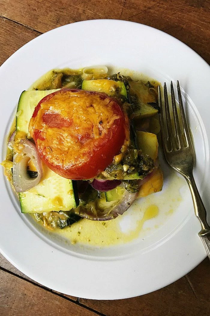casserole with squash zucchini tomatoes onion parsley zucchini and squash recipes on white plate