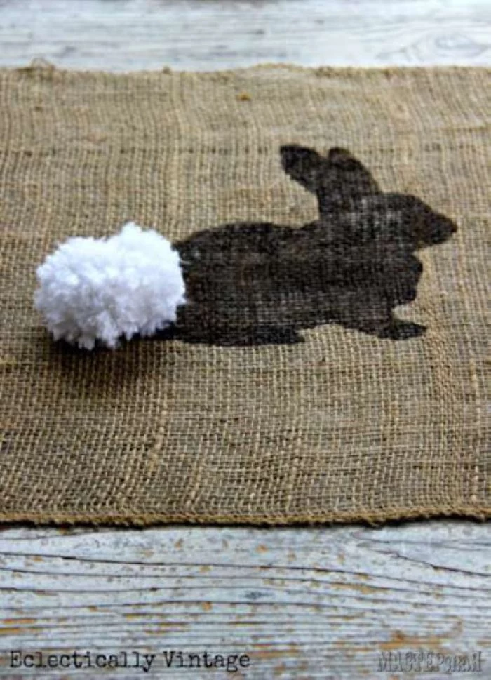 close up photo of bunny pattern with white pom pom for tail easter table décor diy easter table runner