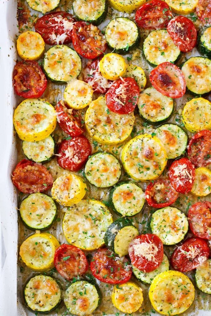 close up photo of zucchini squash and tomato slices how to cook yellow squash garnished with cheese