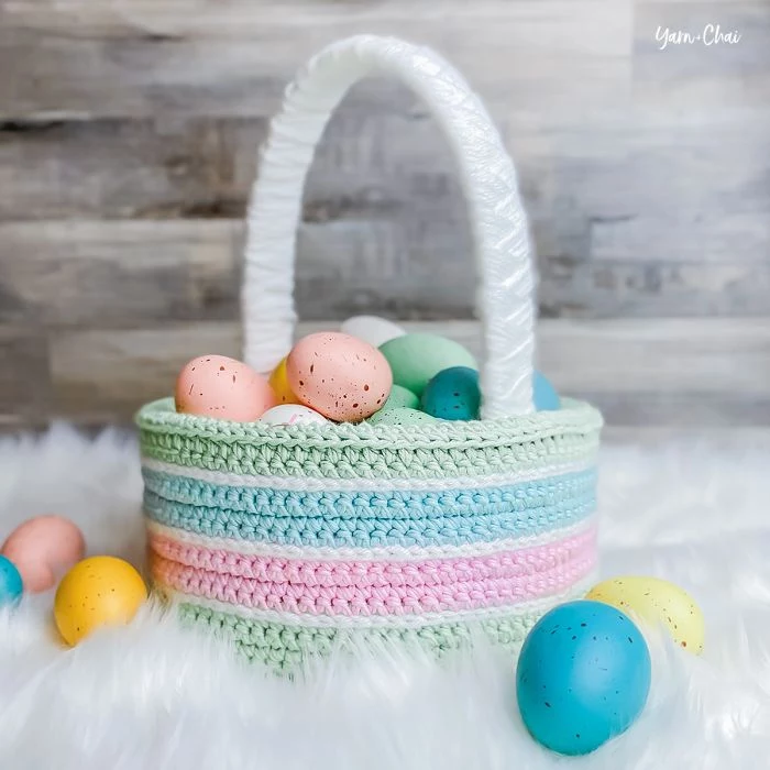 crocheted basket in green blue and pink adult easter basket decorated easter eggs inside