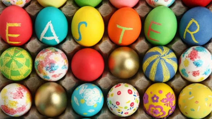 decorated eggs in different colors and patterns spelling easter dying eggs with food coloring