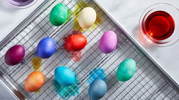 decorated eggs on metal rack dying eggs with food coloring dyed in green blue purple red