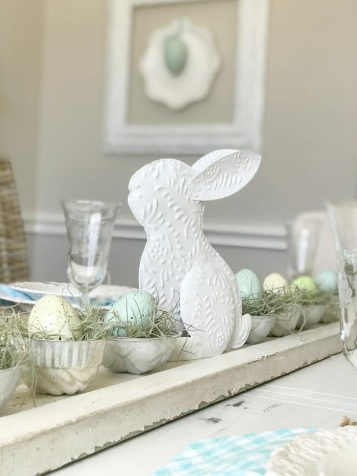 diy easter decorations white ceramic bunny in the middle bowls with eggs in nests