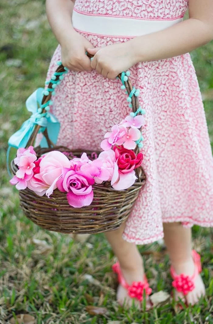 easter basket ideas for toddlers girl wearing blue and red lace dress holding basket with flowers
