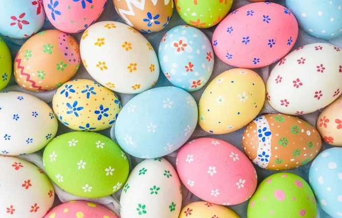 easter eggs in different colors and sizes easter background flower decorations on them