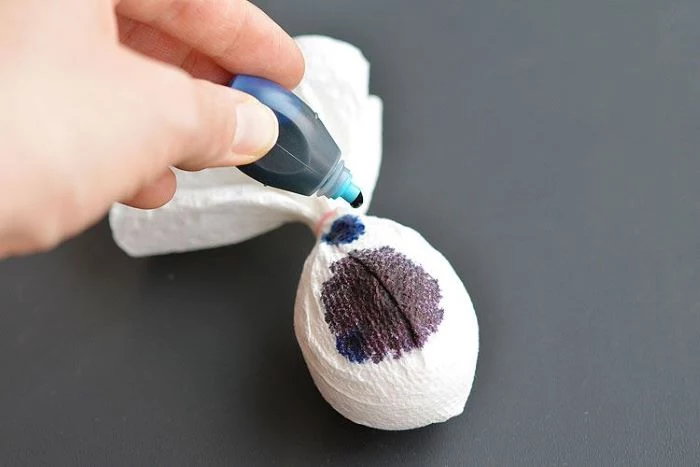 egg wrapped in paper towel dye drops on it how to color easter eggs step by step diy tutorial