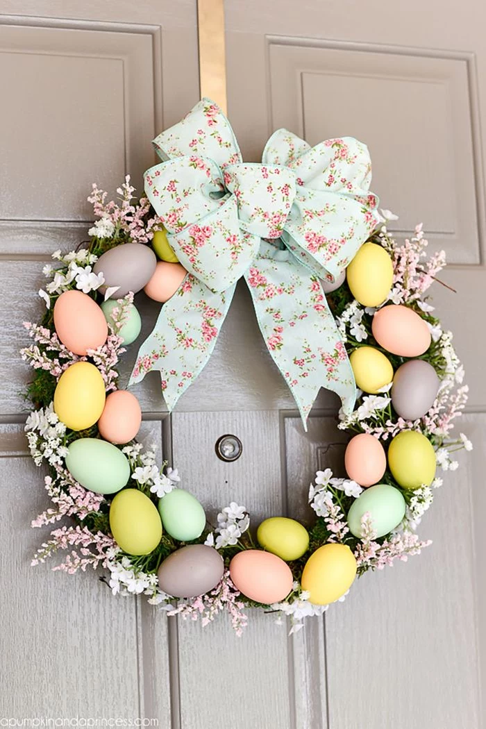 egg wreath made with faux pink and blue flowers easter crafts eggs blue floral ribbon in the middle