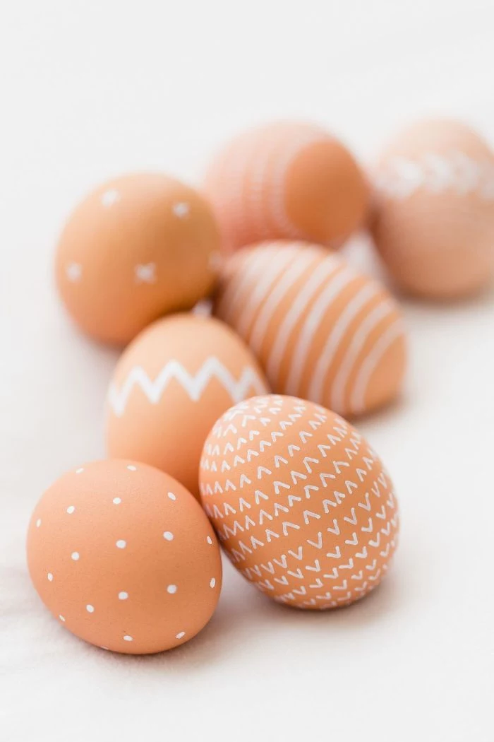 eggs decorated with different white patterns free easter wallpaper placed on white surface