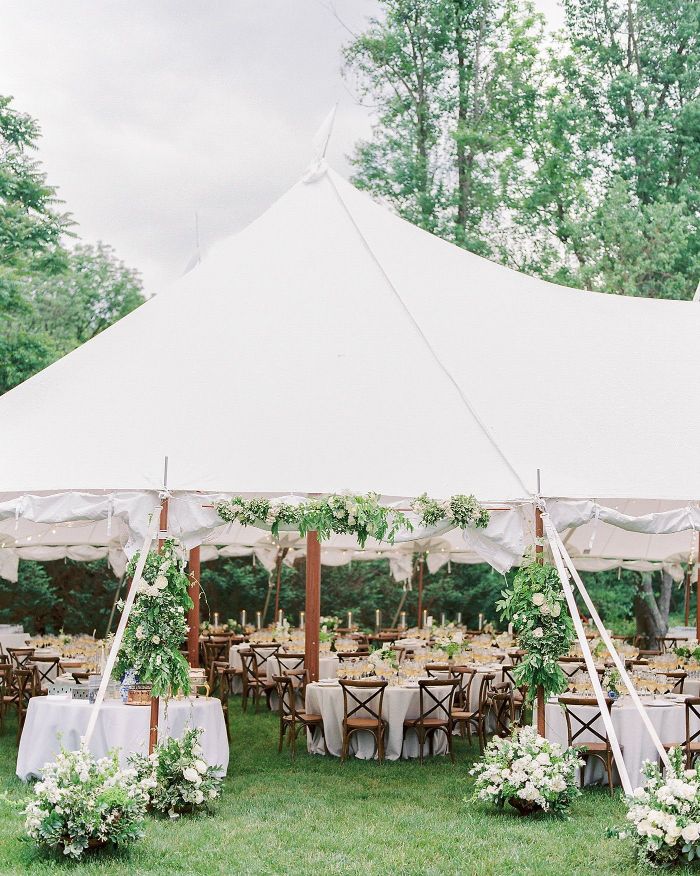 flower arrangements all over entrance to tent diy wedding ideas lots of round tables under the tent