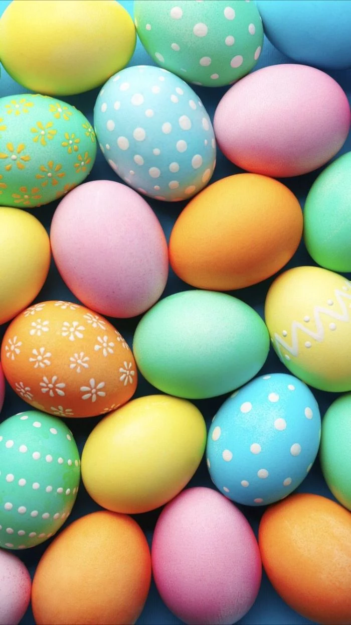 green blue orange pink easter eggs with different patterns free easter wallpaper placed on blue surface