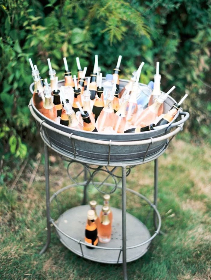 home wedding ideas metal table filled with ice small bottles of moet with straws water bottles