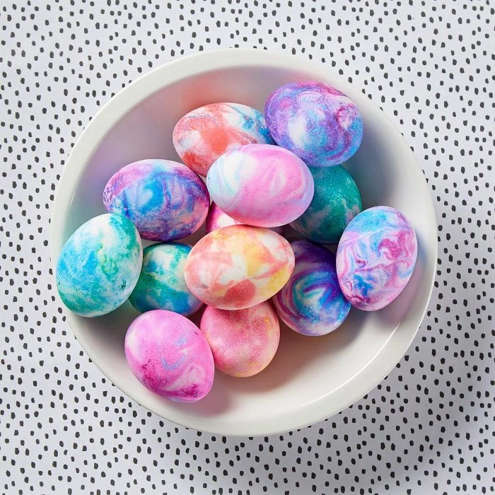 homemade egg dye white bowl filled with eggs in different colors dyed with shaving cream