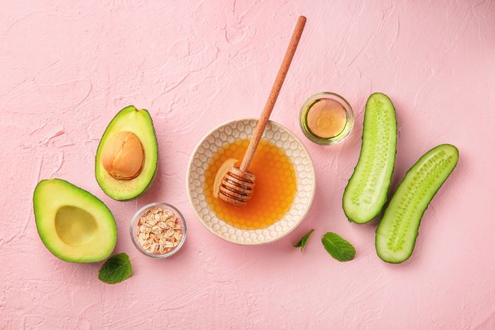 honey mask ingredients how to make masks at home with cucumber avocado oats arranged on pink surface