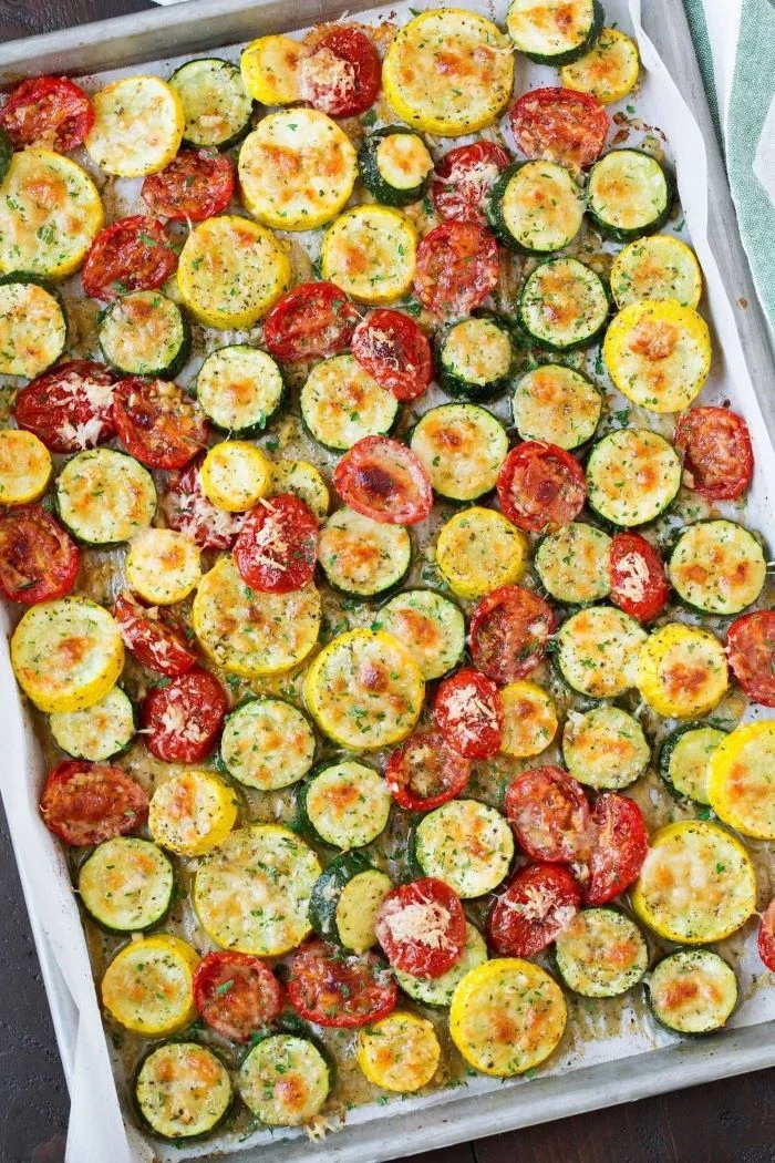 large sheet pan how to cook yellow squash zucchini and tomato slices arranged on it with cheese