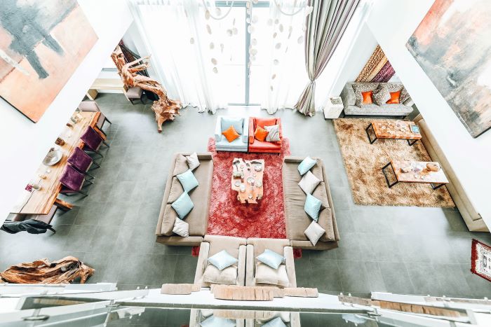 living room photographed from above living room design mistakes colorful chairs throw pillows and carpets