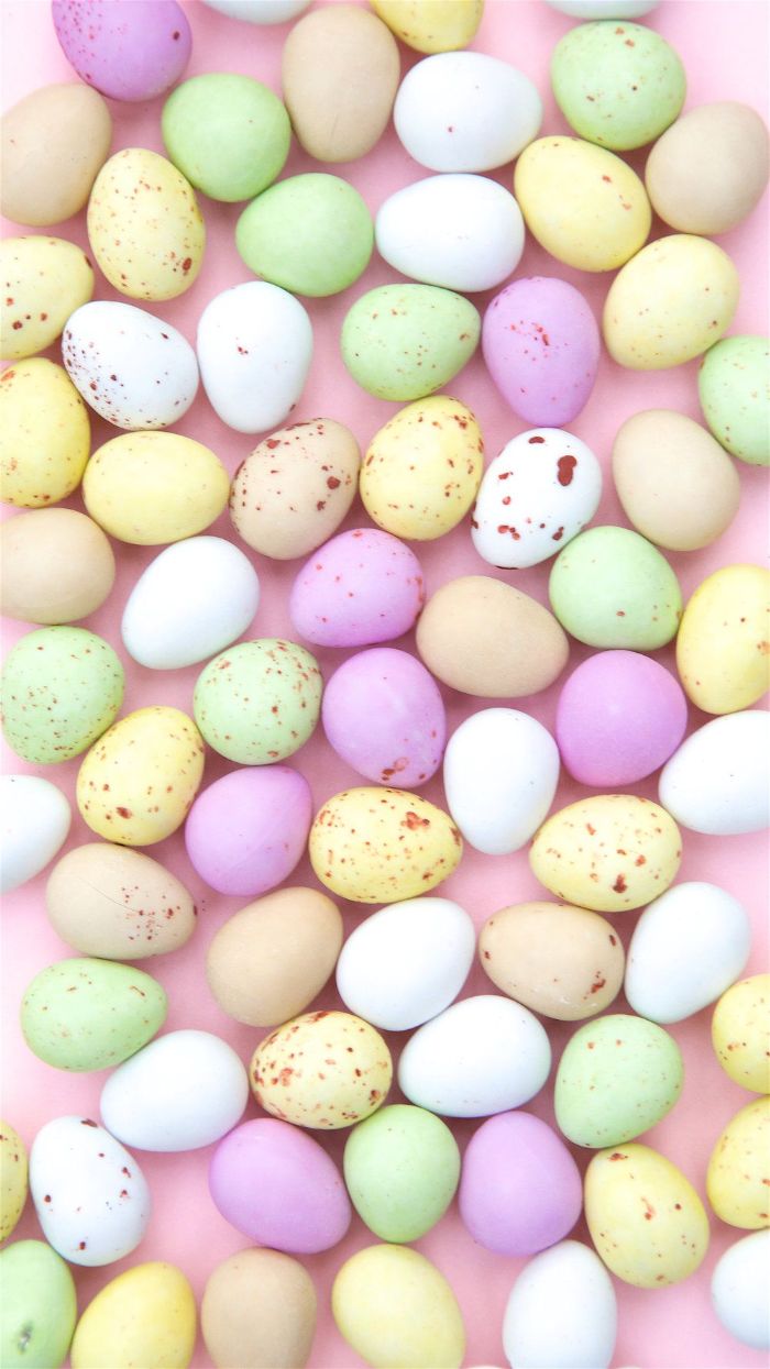 lots of eggs decorated in pastel colors placed on pink surface easter background images