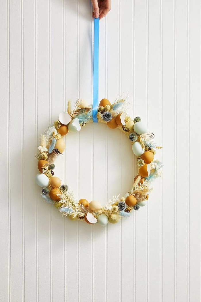 outdoor easter decorations wreath made with eggs and eggshells feathers blue ribbon