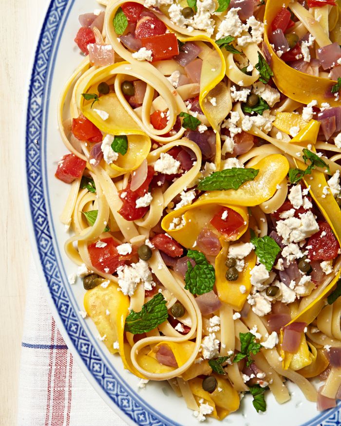 pasta with squash tomatoes onions capers yellow squash recipes garnished with crumbled feta mint leaves
