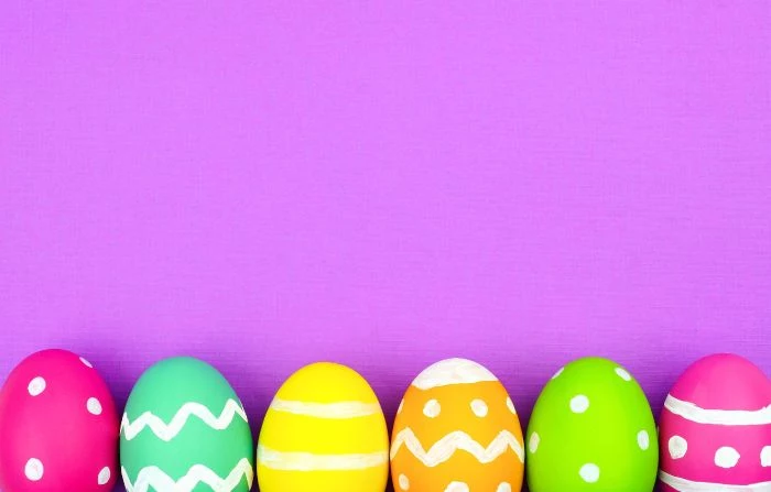 purple background cute easter wallpaper six eggs all in different colors with different patterns at the bottom of the photo