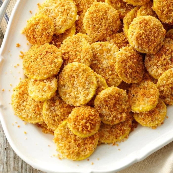 summer squash recipes small bites baked covered with breadcrumbs and parmesan cheese on white plate