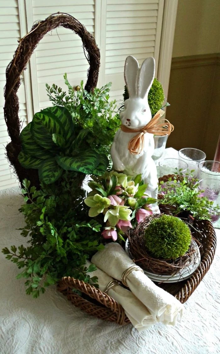 table centerpiece with green potted plants easter crafts white ceramic bunny in a basket