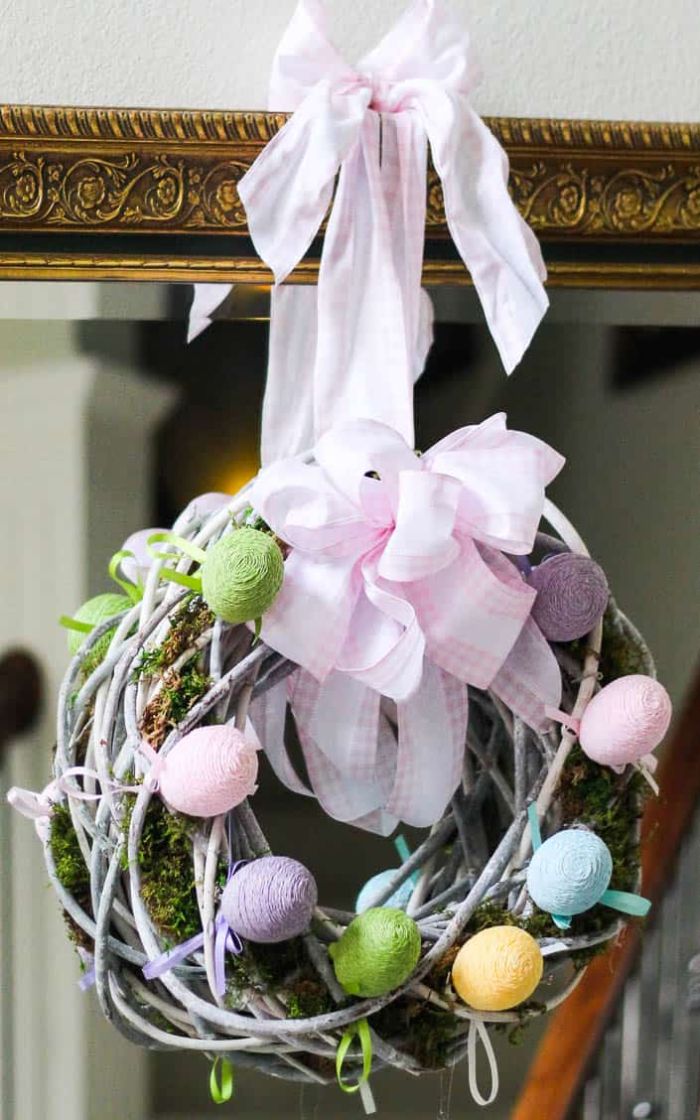 wreath made with white branches faux moss and eggs diy easter decorations large pink and white ribbon