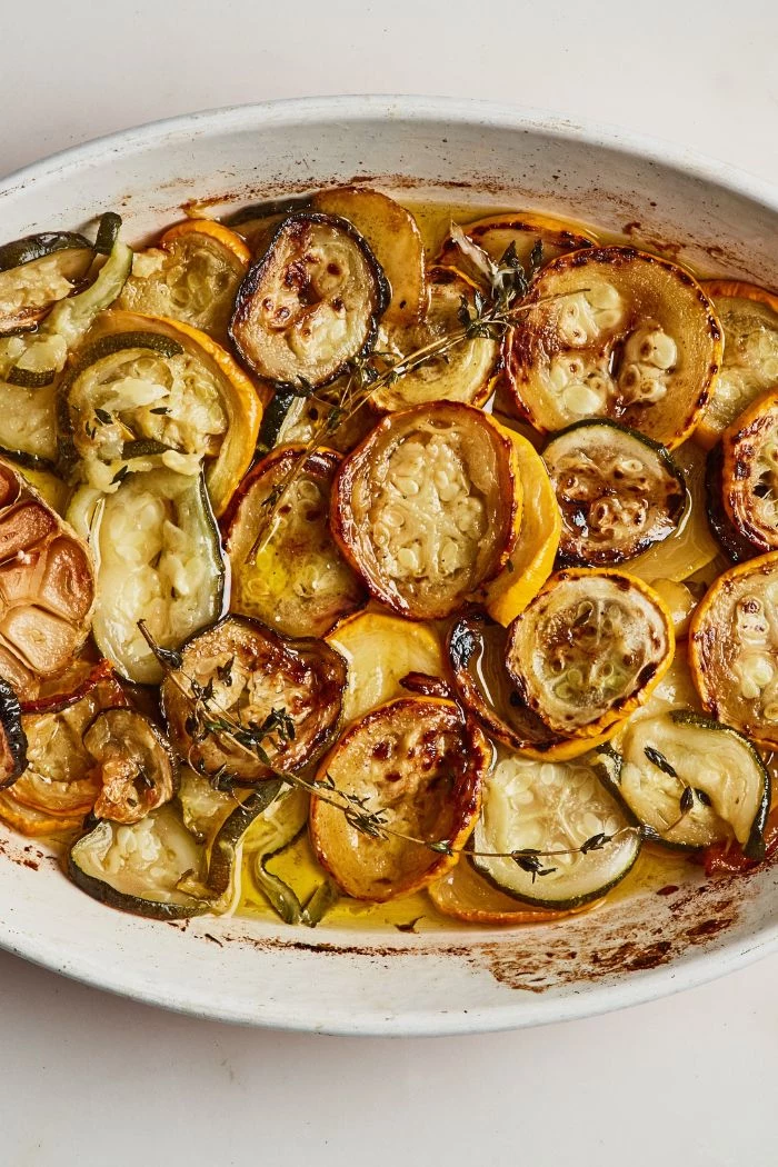 yellow squash recipes baked squash and zucchini slices in butter garnished with thyme twigs