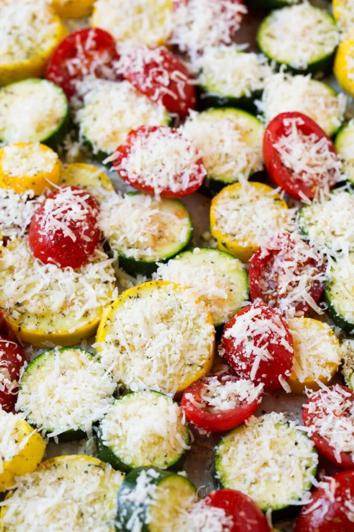 zucchini and yellow squash recipes close up photo of squash zucchini and tomato slices covered with grated cheese
